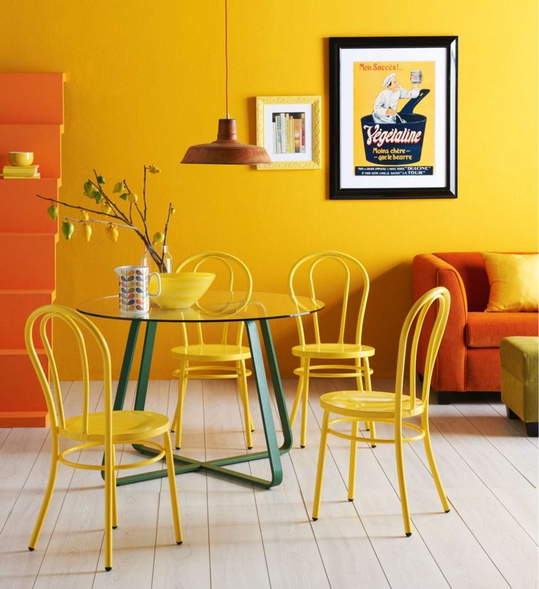 associer les couleurs salle à manger jaune orange noir séjour canapé table à manger en verre pieds bleus 