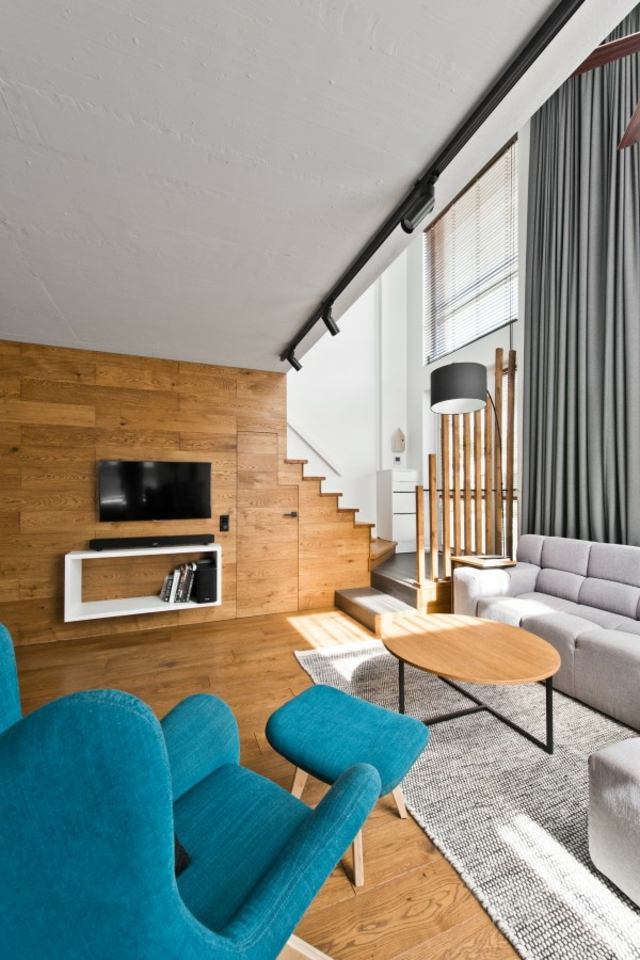 table en bois basse design fauteuil canapé gris tapis de sol luminaire suspendu