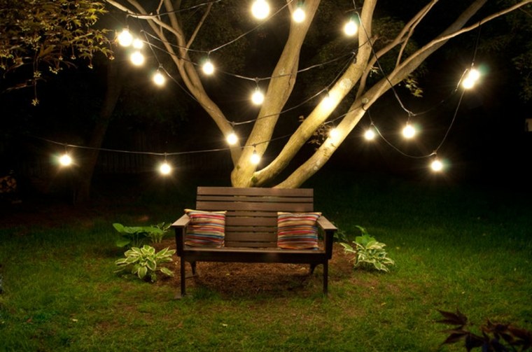 guirlande romantique idée éclairage extérieur jardin banc de jardin coussins