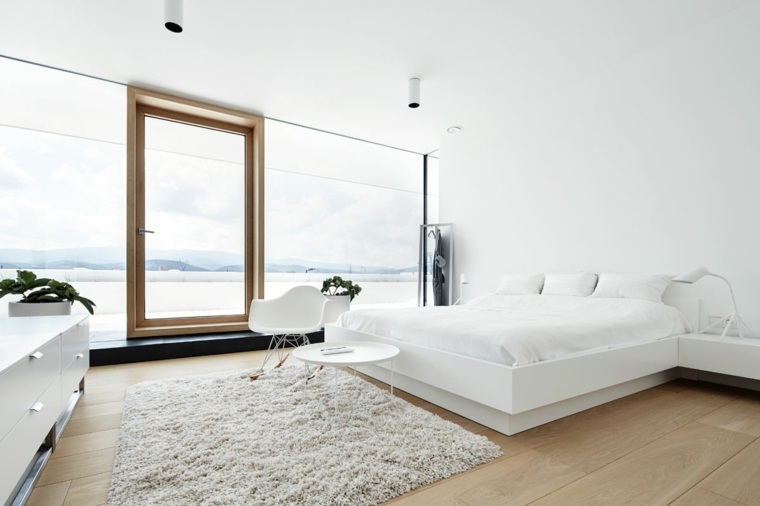 intérieur chambre blanche design lit tête de lit tapis sol cadre bois