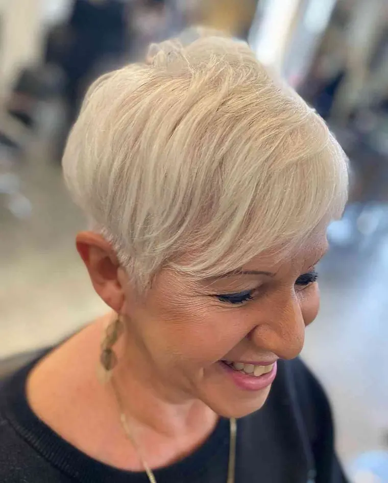 pixie tendance pour femme de 55 ans plus aux cheveux gris avec la frange sur le côté