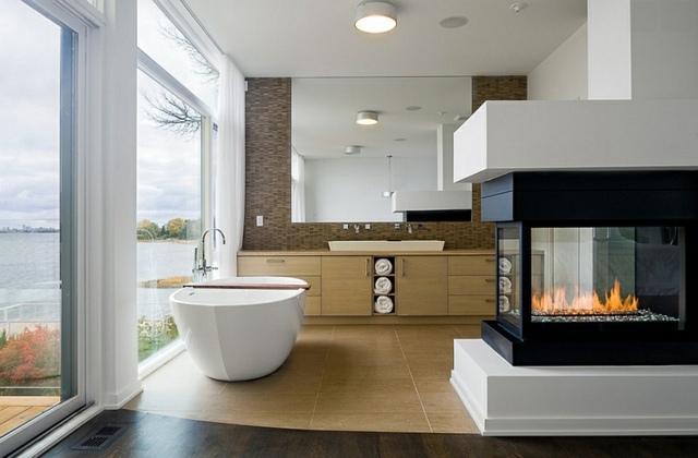 salle de bains spa design baignoire ilot ovale vitrage feu cheminee